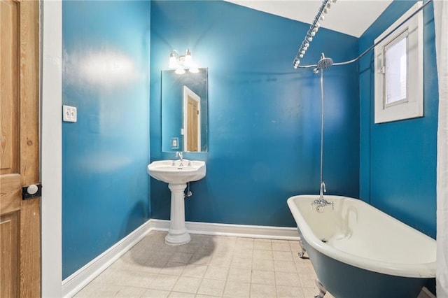 full bathroom featuring a soaking tub, baseboards, and walk in shower