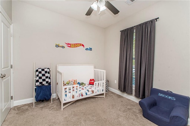 bedroom featuring a ceiling fan, carpet flooring, visible vents, and baseboards