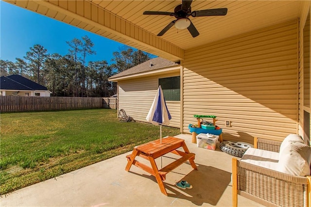 view of patio featuring ceiling fan and fence