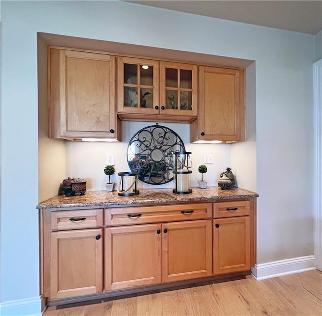 bar with light wood finished floors and baseboards