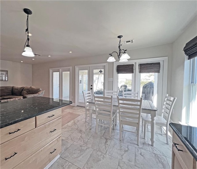 interior space featuring marble finish floor, visible vents, dark stone countertops, and french doors