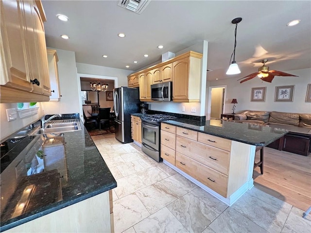 kitchen featuring visible vents, open floor plan, stainless steel appliances, light brown cabinetry, and a sink