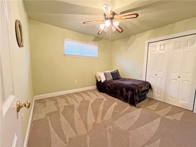 bedroom with a ceiling fan, carpet, a closet, and baseboards