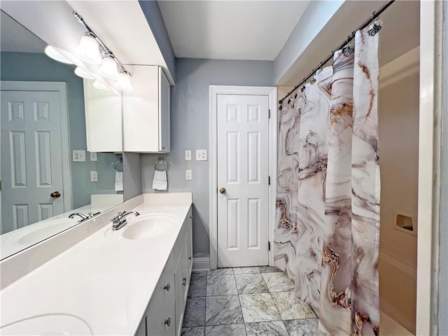 bathroom with marble finish floor, a shower with shower curtain, and vanity