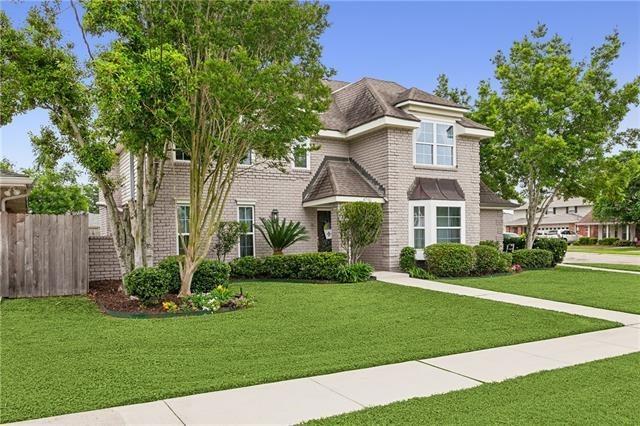 view of front of house with a front yard, brick siding, and fence