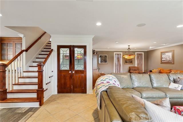 living room featuring light tile patterned flooring, recessed lighting, stairs, french doors, and ornamental molding