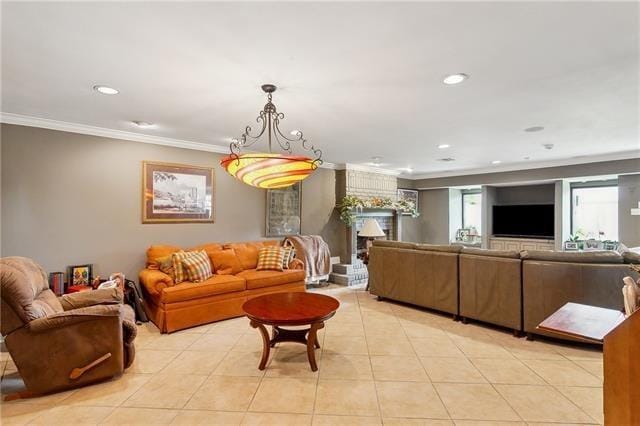 living room with recessed lighting, a fireplace, crown molding, and light tile patterned floors