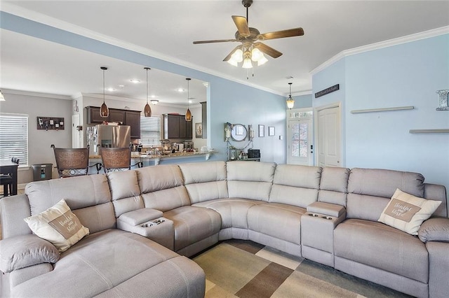 living area featuring ceiling fan and ornamental molding