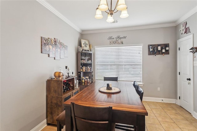 dining area with crown molding, baseboards, and an inviting chandelier