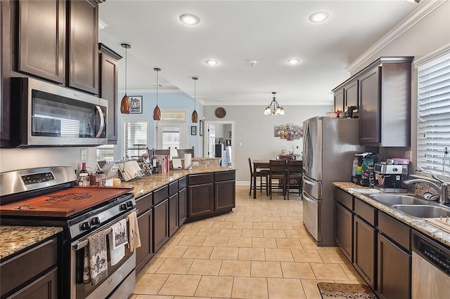 kitchen featuring light tile patterned flooring, a sink, dark brown cabinets, ornamental molding, and appliances with stainless steel finishes