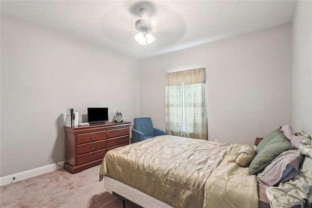 bedroom featuring light colored carpet, ceiling fan, and baseboards