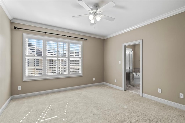 empty room featuring a ceiling fan, carpet, baseboards, and crown molding