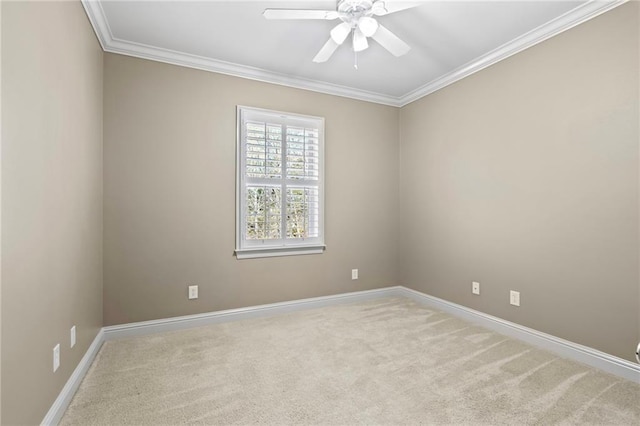 unfurnished room with carpet flooring, crown molding, baseboards, and ceiling fan