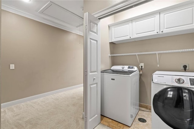 laundry area featuring light carpet, washing machine and dryer, cabinet space, and attic access