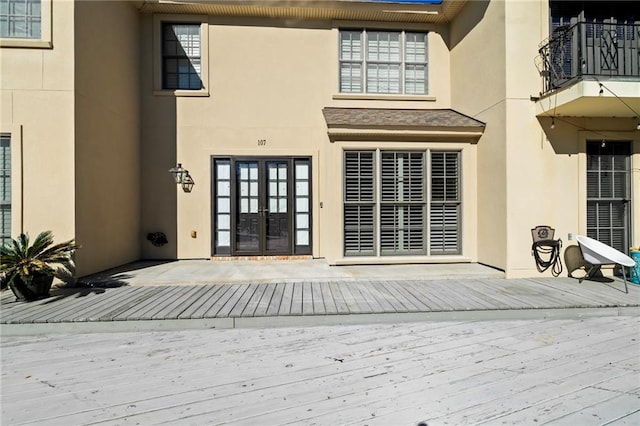 entrance to property with french doors and stucco siding