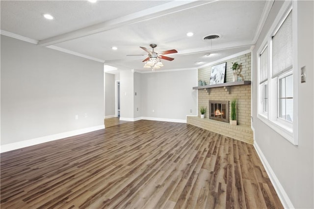 unfurnished living room featuring a brick fireplace, visible vents, crown molding, and baseboards