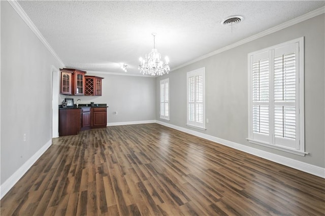 unfurnished living room with visible vents, dark wood finished floors, and a textured ceiling