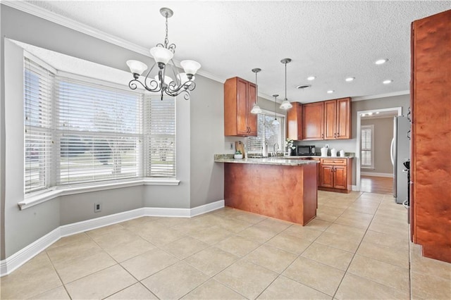 kitchen featuring brown cabinets, crown molding, light tile patterned floors, freestanding refrigerator, and a peninsula