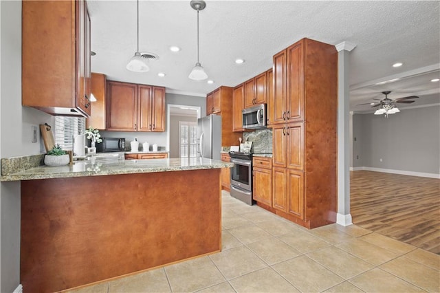 kitchen with light tile patterned floors, stainless steel appliances, a peninsula, visible vents, and decorative light fixtures