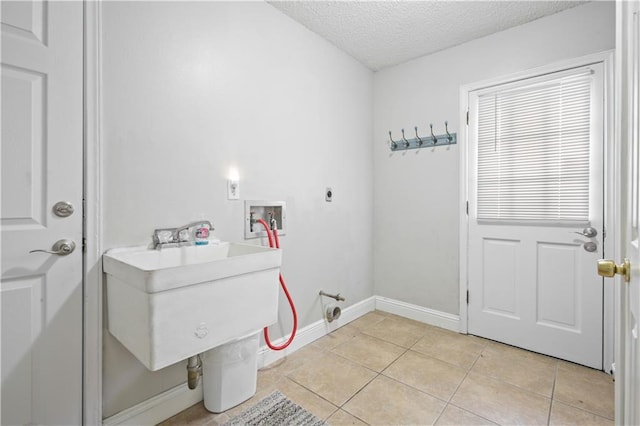 clothes washing area featuring laundry area, light tile patterned floors, a textured ceiling, hookup for an electric dryer, and washer hookup