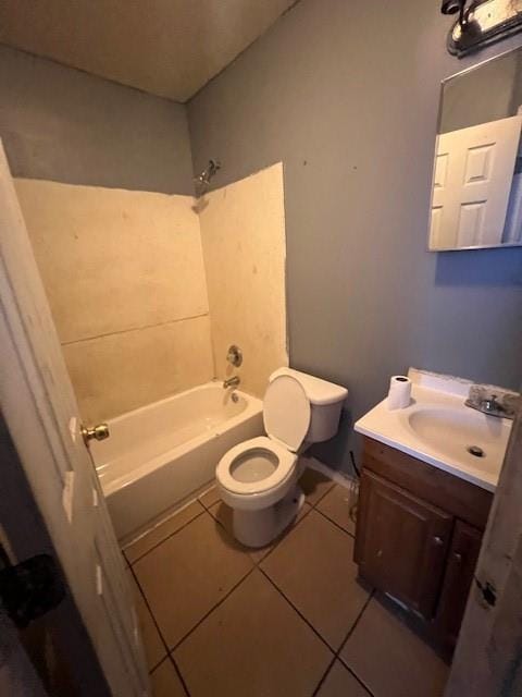 bathroom with toilet, vanity,  shower combination, and tile patterned floors