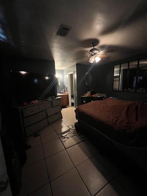 bedroom with visible vents, ceiling fan, and light tile patterned floors