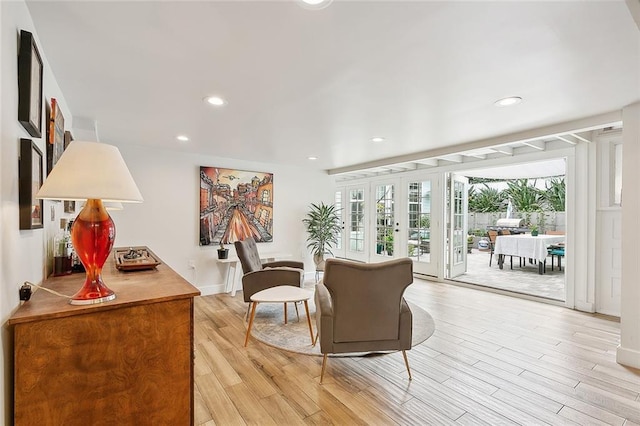 living room featuring light wood-type flooring, french doors, baseboards, and recessed lighting