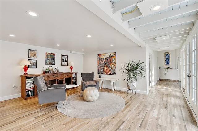 living area featuring baseboards, light wood-type flooring, and recessed lighting