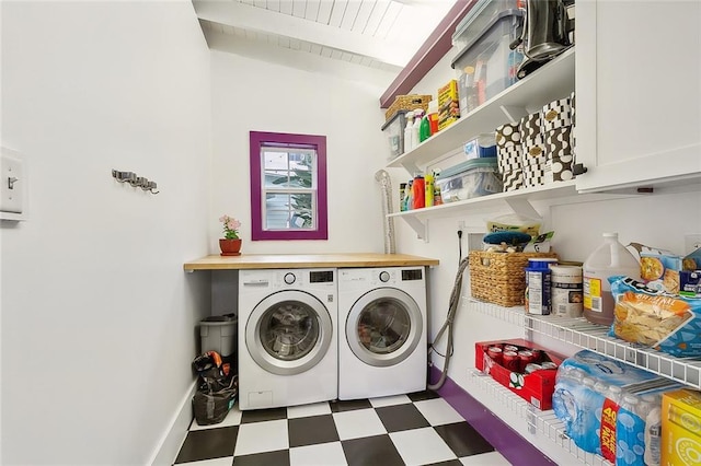 laundry room with cabinet space, washer and dryer, and tile patterned floors