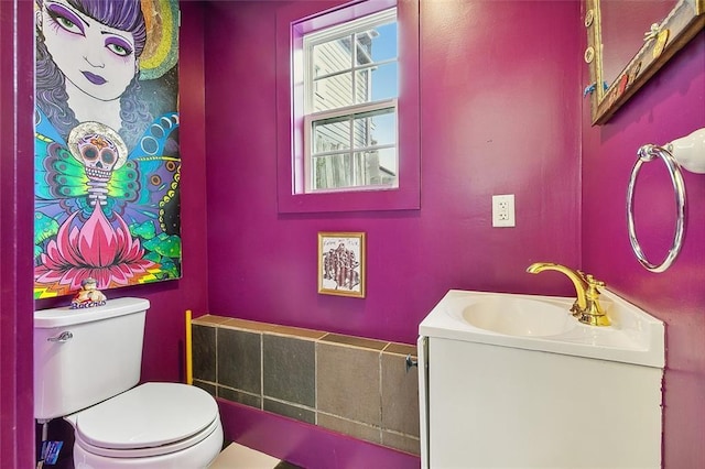 bathroom featuring toilet and vanity