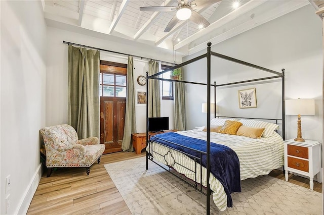 bedroom featuring lofted ceiling with beams, ceiling fan, wood finished floors, and wood ceiling