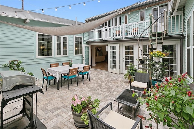 view of patio featuring french doors, outdoor dining area, and grilling area