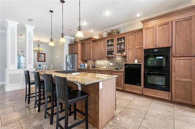 kitchen with a kitchen breakfast bar, appliances with stainless steel finishes, brown cabinets, a center island, and tasteful backsplash