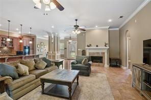 living area featuring ceiling fan, a fireplace, ornamental molding, and recessed lighting