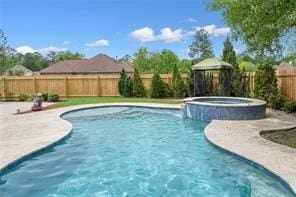 view of swimming pool featuring a gazebo, a patio area, a fenced backyard, and a pool with connected hot tub