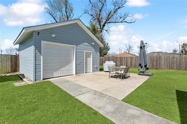 detached garage with driveway and fence