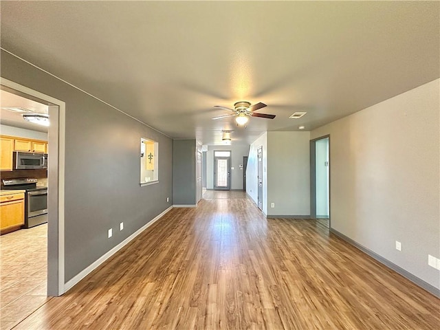 unfurnished living room with visible vents, ceiling fan, light wood-style flooring, and baseboards