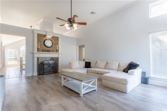 living room featuring high vaulted ceiling, wood finished floors, and a wealth of natural light