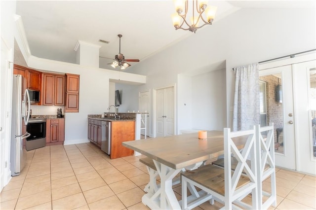 kitchen featuring visible vents, appliances with stainless steel finishes, brown cabinets, a peninsula, and a sink