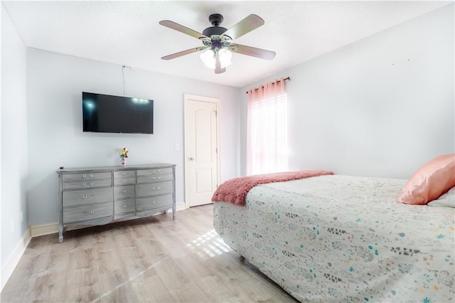 bedroom featuring ceiling fan, wood finished floors, and baseboards