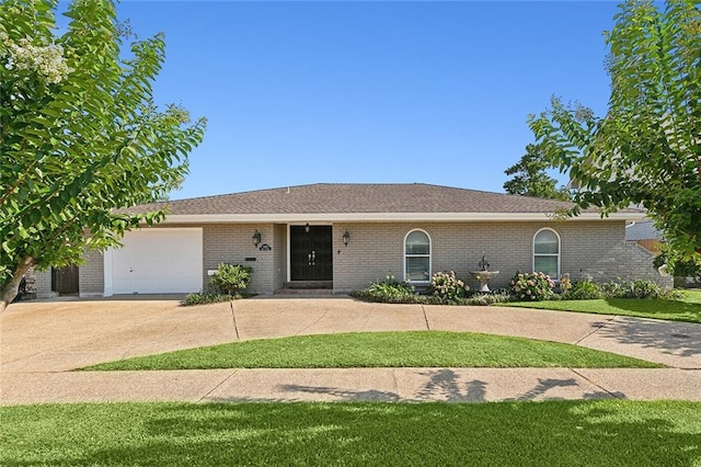 ranch-style house featuring a garage, concrete driveway, and brick siding