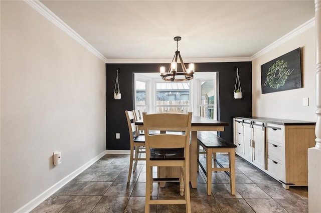 dining room with an inviting chandelier, baseboards, and crown molding