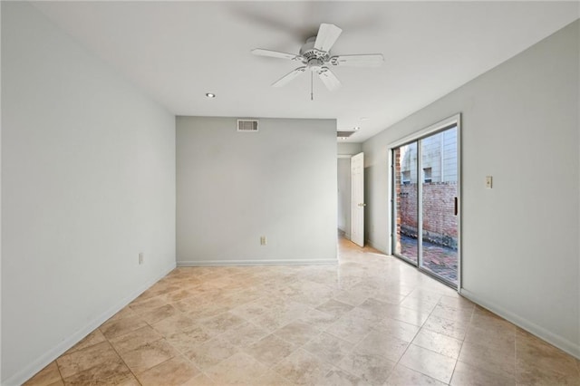 spare room featuring a ceiling fan, visible vents, and baseboards