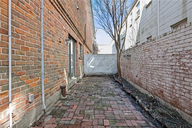 view of home's exterior featuring brick siding and a fenced backyard