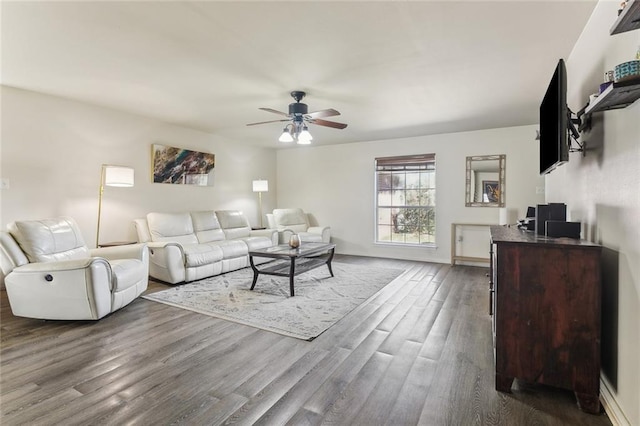 living room featuring ceiling fan and dark wood finished floors