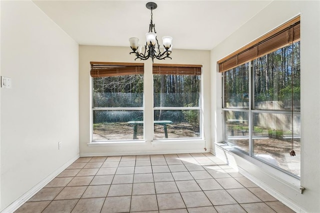 340 Colonial Ct, Mandeville, LA 70471 - unfurnished dining area featuring an inviting chandelier, tile patterned flooring, and baseboards