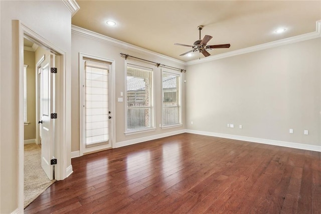 spare room featuring a ceiling fan, baseboards, crown molding, and hardwood / wood-style floors