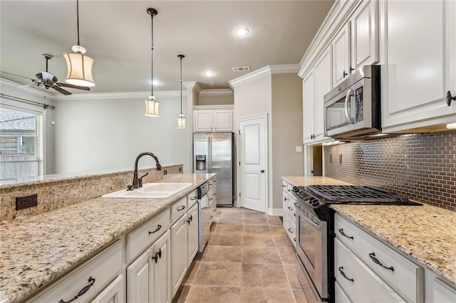 kitchen featuring decorative light fixtures, tasteful backsplash, appliances with stainless steel finishes, a ceiling fan, and a sink