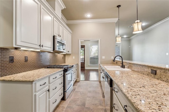 kitchen featuring decorative backsplash, appliances with stainless steel finishes, ornamental molding, a sink, and light stone countertops