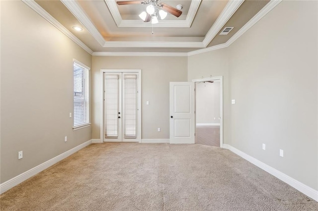 unfurnished bedroom featuring light carpet, visible vents, french doors, ornamental molding, and a tray ceiling